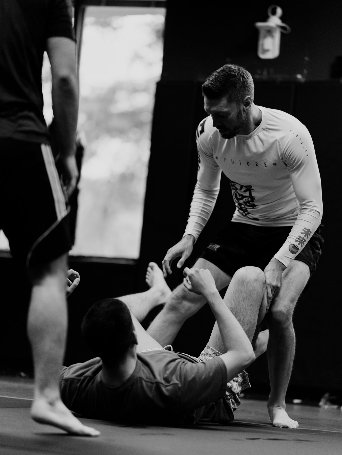 Loyal Legion head coach drilling a no-gi guard exchange with a student on the mat.